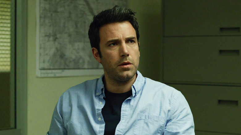 Nick Dunne sitting down in Gone Girl