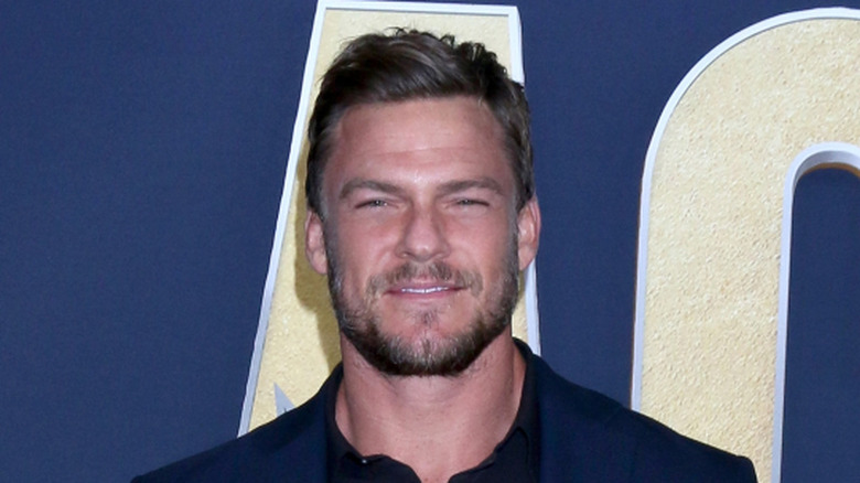 Alan Ritchson on a red carpet