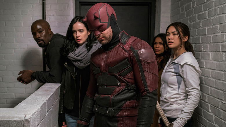 Daredevil and Jessica Jones with their allies in The Defenders